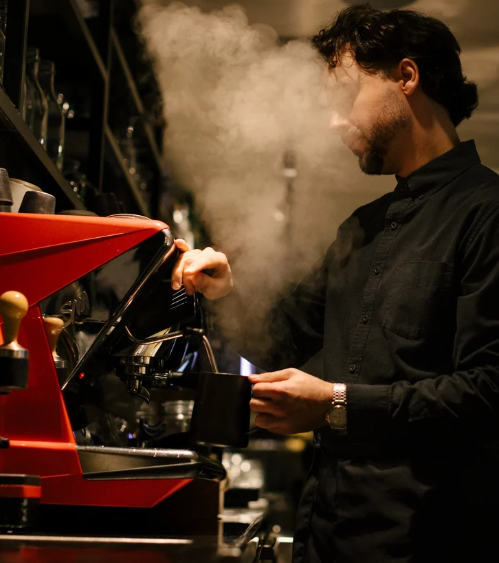 Man preparing coffee at an espresso machine