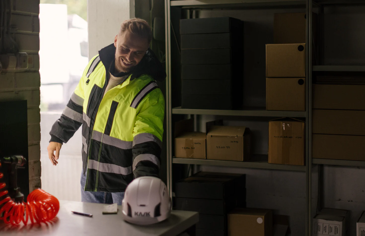 Worker wearing a high-visibility jacket in a workshop