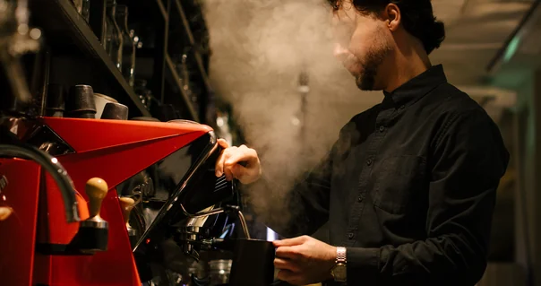 Man preparing coffee at an espresso machine